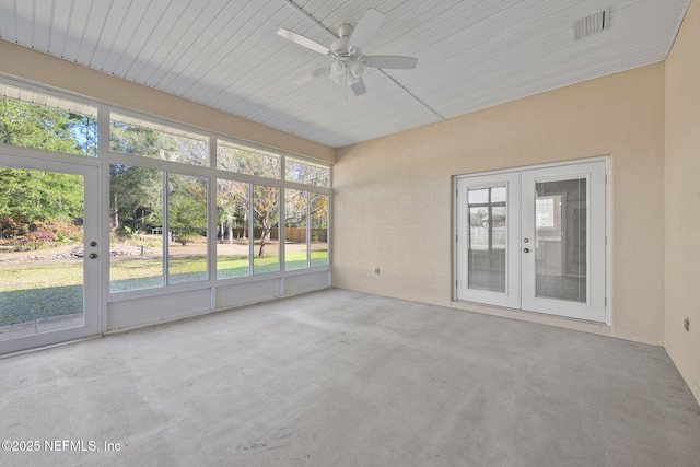 unfurnished sunroom featuring french doors and ceiling fan