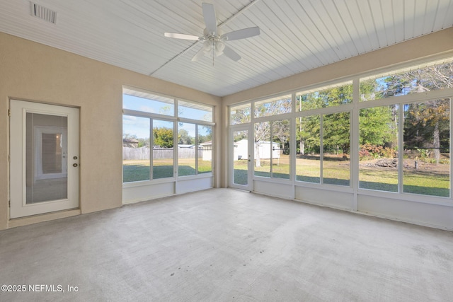 unfurnished sunroom with ceiling fan