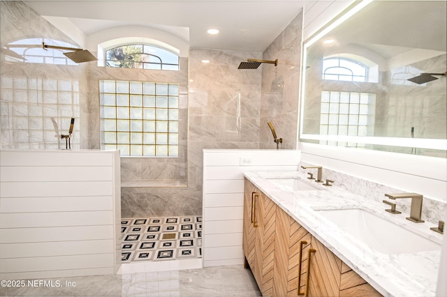 bathroom with vanity, tile walls, and a tile shower