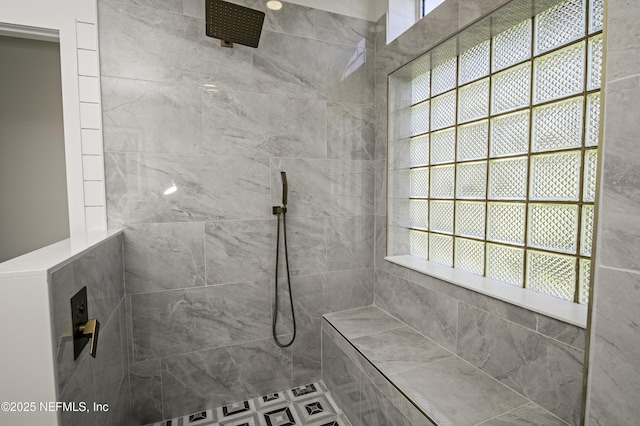 bathroom with a tile shower