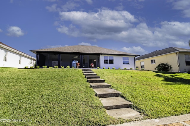 back of house with a lawn