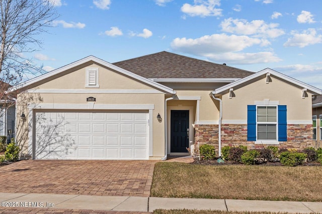 ranch-style house featuring a garage and a front lawn