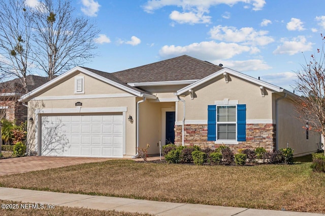 ranch-style home with a garage and a front lawn