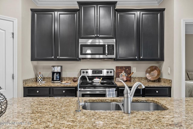 kitchen featuring sink, ornamental molding, light stone countertops, and appliances with stainless steel finishes