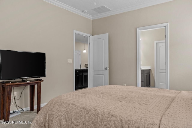 carpeted bedroom featuring ornamental molding and ensuite bath