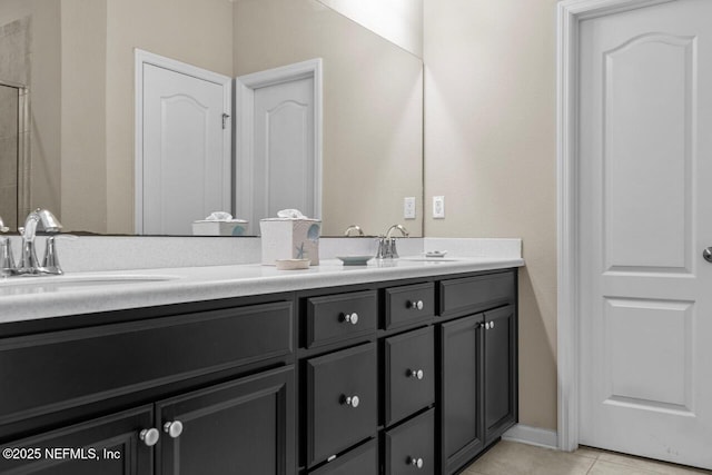 bathroom with tile patterned floors and vanity