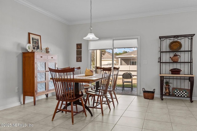 tiled dining room featuring crown molding