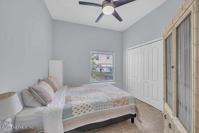 carpeted bedroom with a closet and ceiling fan