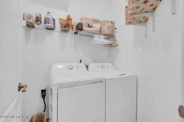 clothes washing area featuring washer and clothes dryer