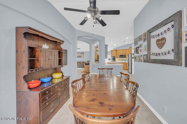 tiled dining room featuring ceiling fan