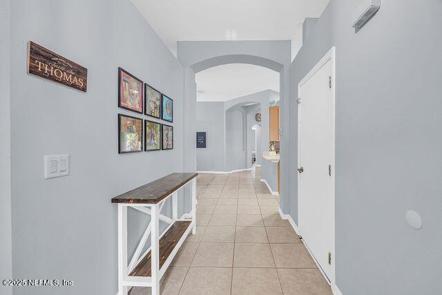 hall with light tile patterned flooring