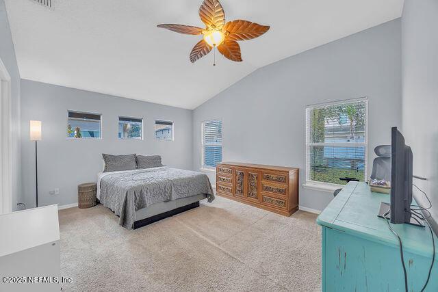 bedroom featuring ceiling fan, lofted ceiling, and light colored carpet