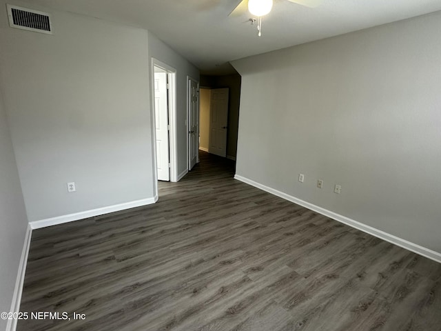 empty room featuring ceiling fan and dark hardwood / wood-style floors