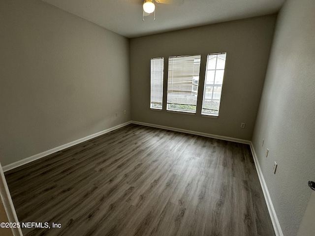 spare room with ceiling fan and dark hardwood / wood-style flooring