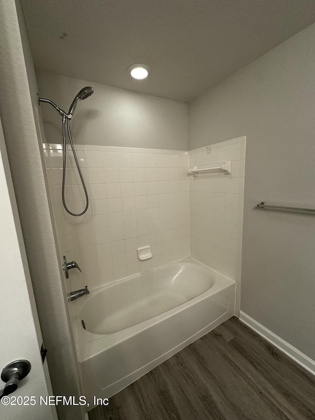 bathroom featuring bathtub / shower combination and hardwood / wood-style floors