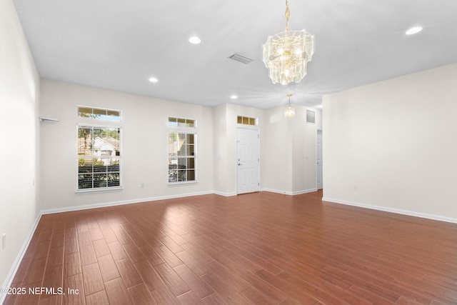 spare room featuring a notable chandelier