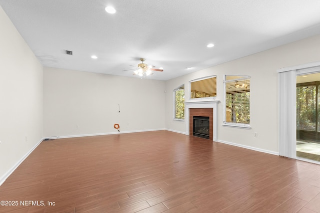 unfurnished living room with hardwood / wood-style flooring and ceiling fan