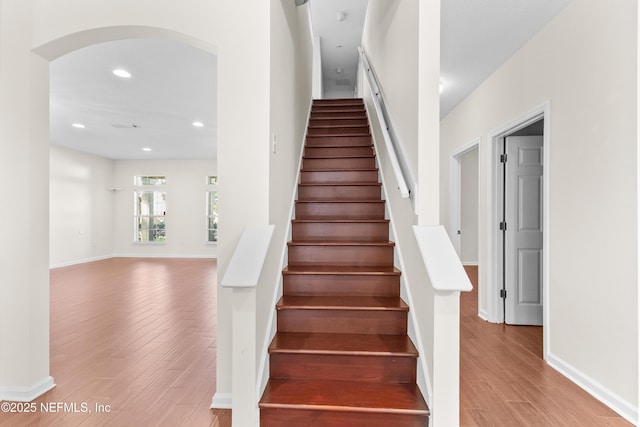 stairs with wood-type flooring