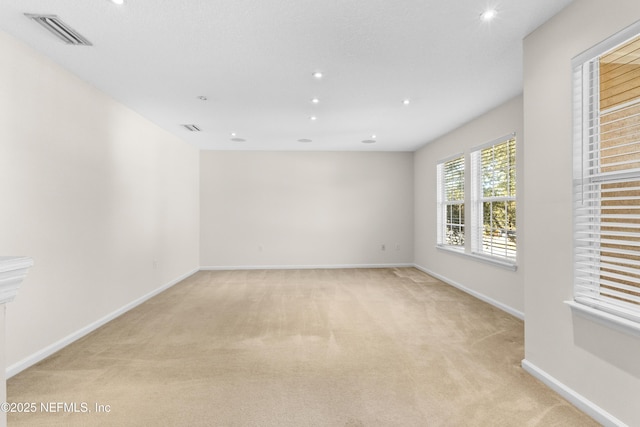 spare room with light colored carpet