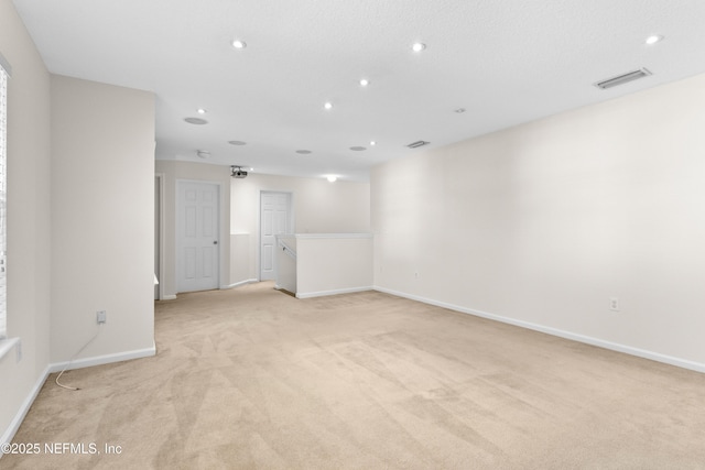 unfurnished room featuring light colored carpet