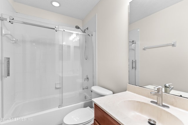 full bathroom with enclosed tub / shower combo, vanity, a textured ceiling, and toilet