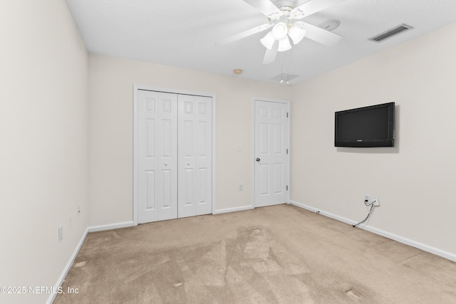 unfurnished bedroom with light carpet and ceiling fan