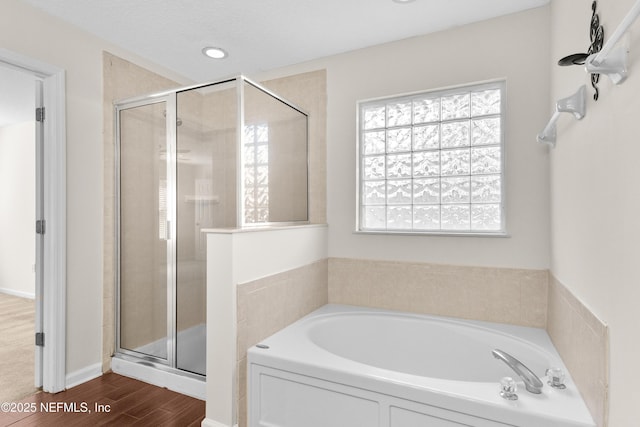 bathroom featuring separate shower and tub