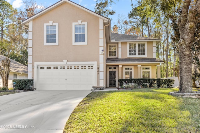 view of front property featuring a garage and a front yard