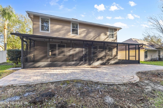 back of house featuring a sunroom and a patio area