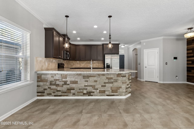 kitchen featuring tasteful backsplash, appliances with stainless steel finishes, dark brown cabinets, and light stone counters