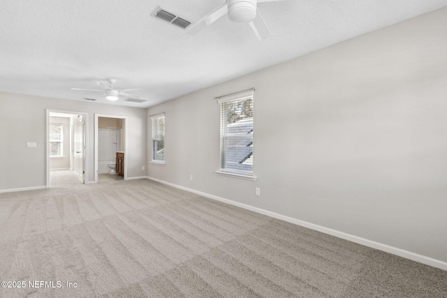 empty room with light colored carpet and ceiling fan