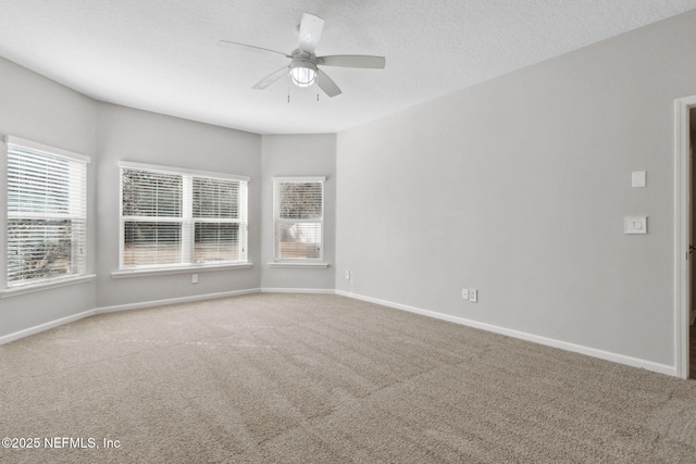 spare room featuring carpet flooring, a textured ceiling, and ceiling fan