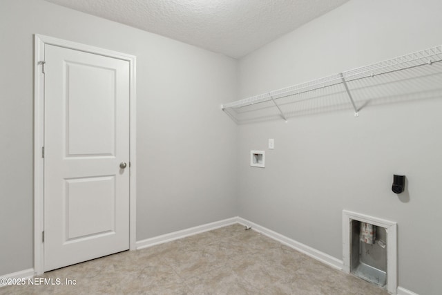 laundry room with washer hookup and a textured ceiling