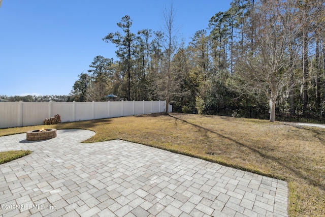 view of yard with a patio and a fire pit