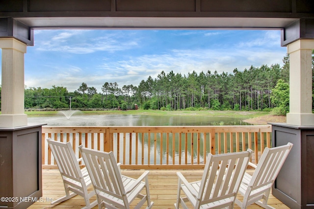 wooden terrace featuring a water view