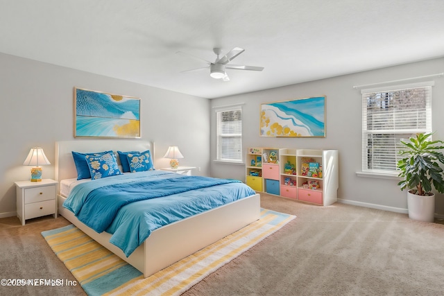 carpeted bedroom with ceiling fan and multiple windows