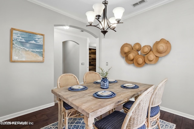 dining room featuring ornamental molding, dark hardwood / wood-style floors, and a notable chandelier