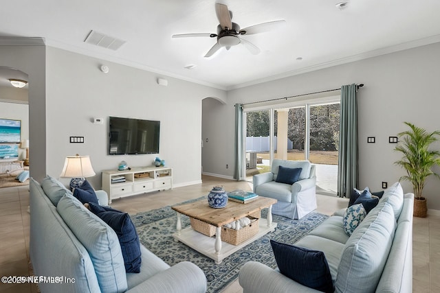 tiled living room featuring ornamental molding and ceiling fan