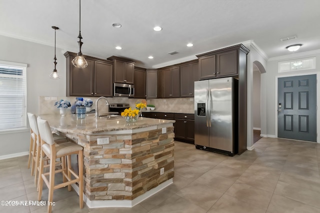 kitchen featuring sink, crown molding, hanging light fixtures, stainless steel appliances, and kitchen peninsula