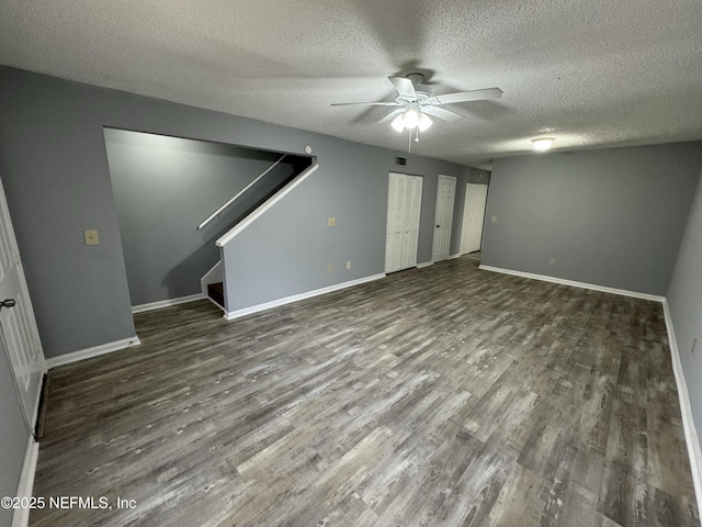 interior space with dark hardwood / wood-style flooring, ceiling fan, and a textured ceiling