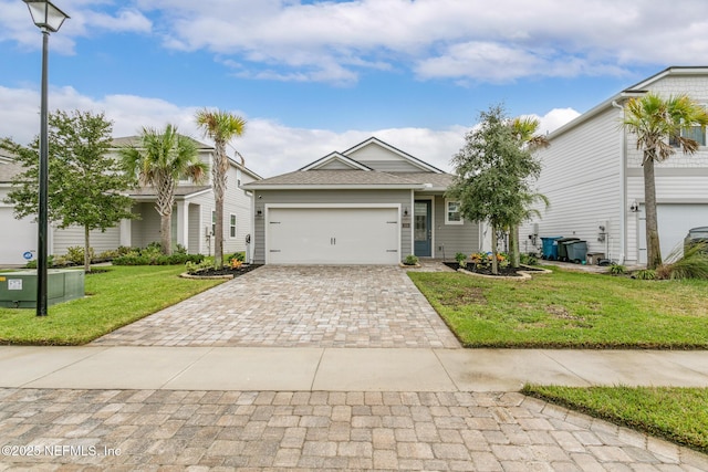 view of front facade with a garage and a front lawn