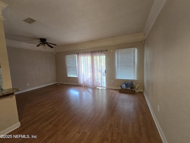 spare room featuring crown molding, dark wood-type flooring, a textured ceiling, and ceiling fan