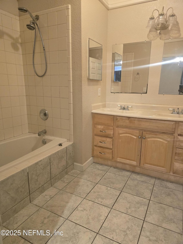 bathroom with tile patterned floors, tiled shower / bath, and vanity