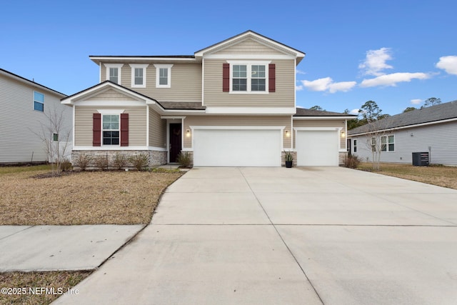 view of front facade featuring stone siding, central AC, an attached garage, and driveway