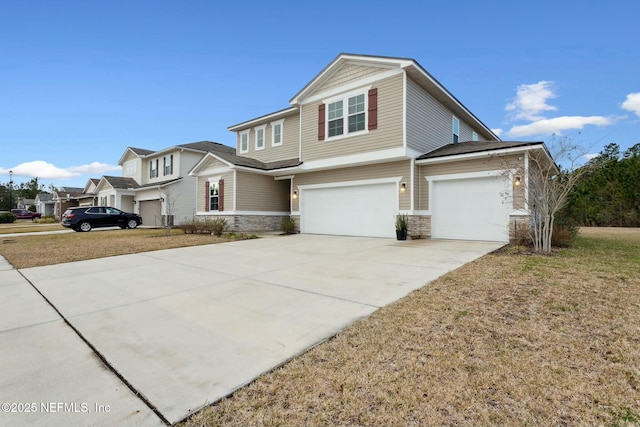 view of front of property with concrete driveway, stone siding, and an attached garage