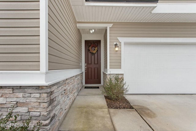 doorway to property featuring concrete driveway