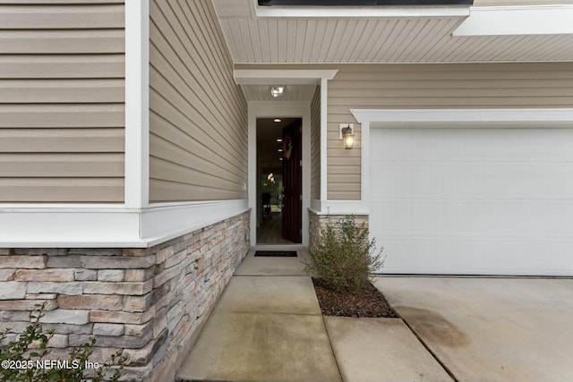 view of exterior entry featuring driveway