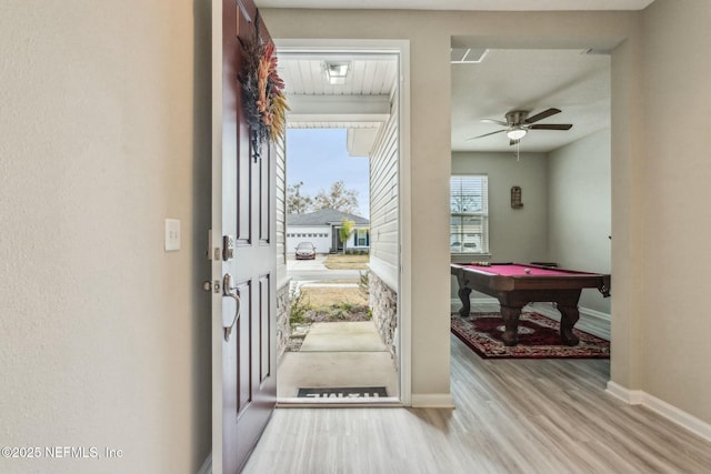 foyer entrance featuring pool table, wood finished floors, a ceiling fan, and baseboards