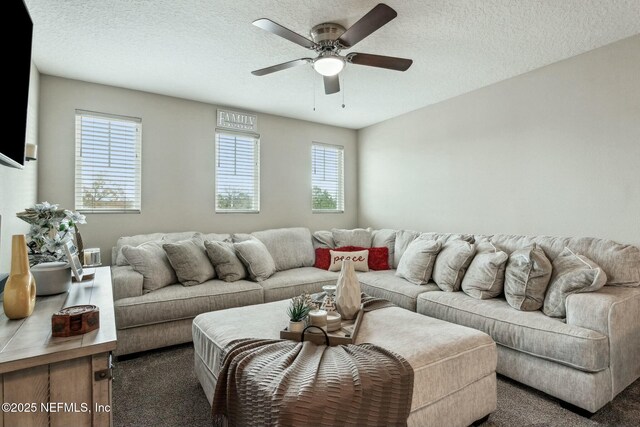 carpeted living room with a ceiling fan and a textured ceiling