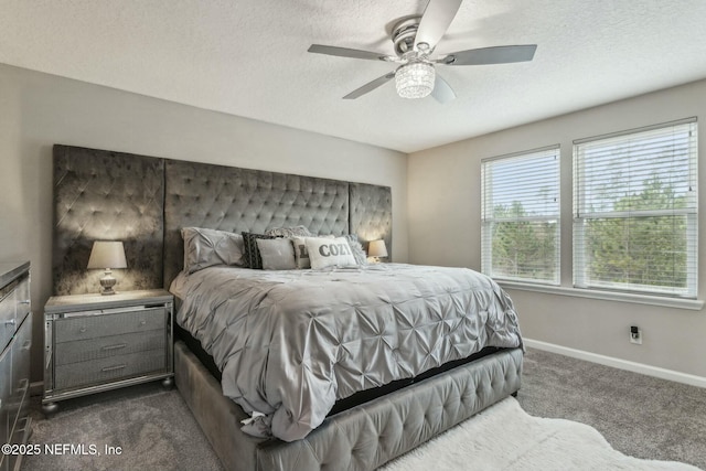 bedroom with a textured ceiling, ceiling fan, dark carpet, and baseboards